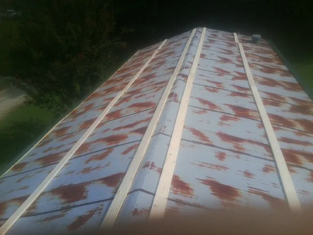 Rusted metal roof panels with new wood purlins before replacement — Storm Damage Roof Repair in Freehold by Roofing Brothers