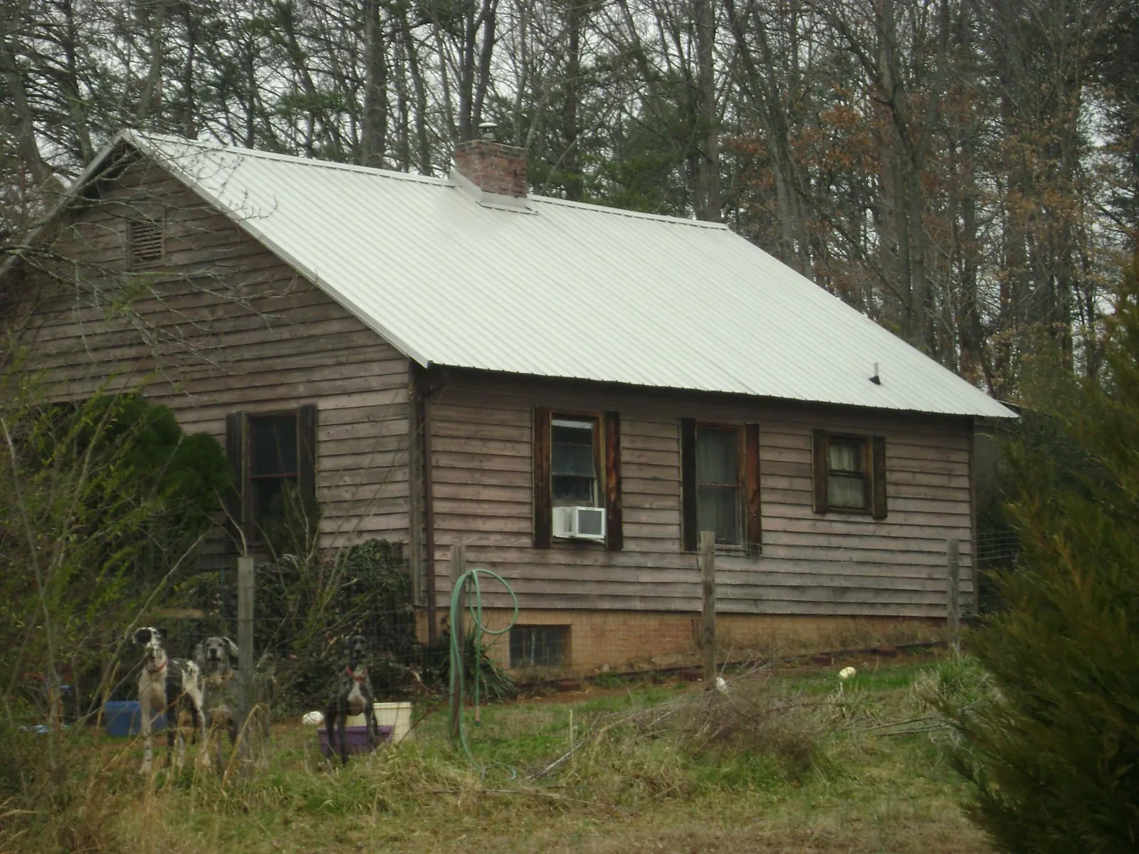 White metal roof on an old wood sided farmhouse, from a Metal Roof Installation job in Freehold